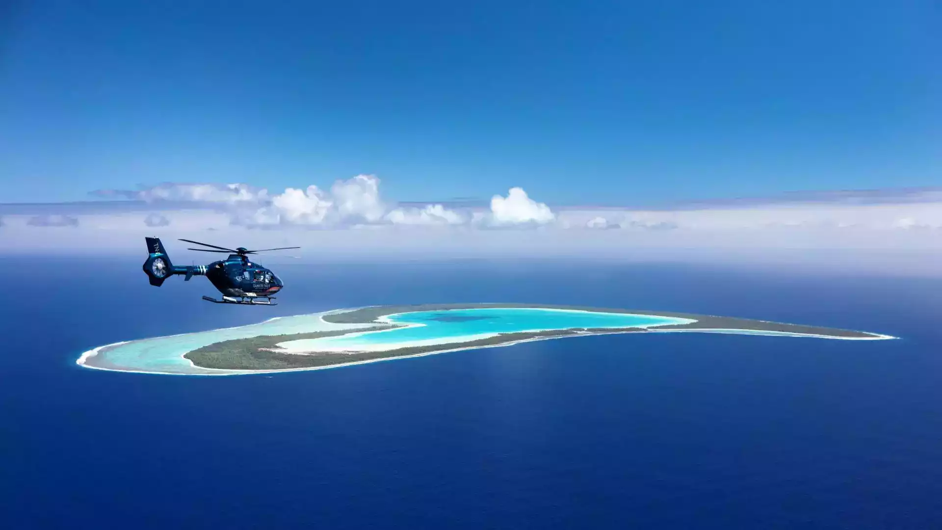 Helicopter flight over Tupai heart-shaped island Bora Bora Tahiti Nui Helicopters French Polynesia