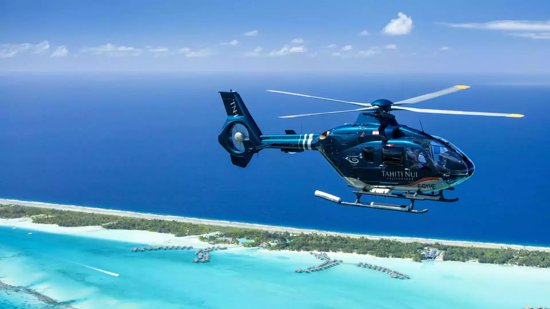 Scenic helicopter flight Bora Bora lagoon overwater bungalows Mt Otemanu French Polynesia