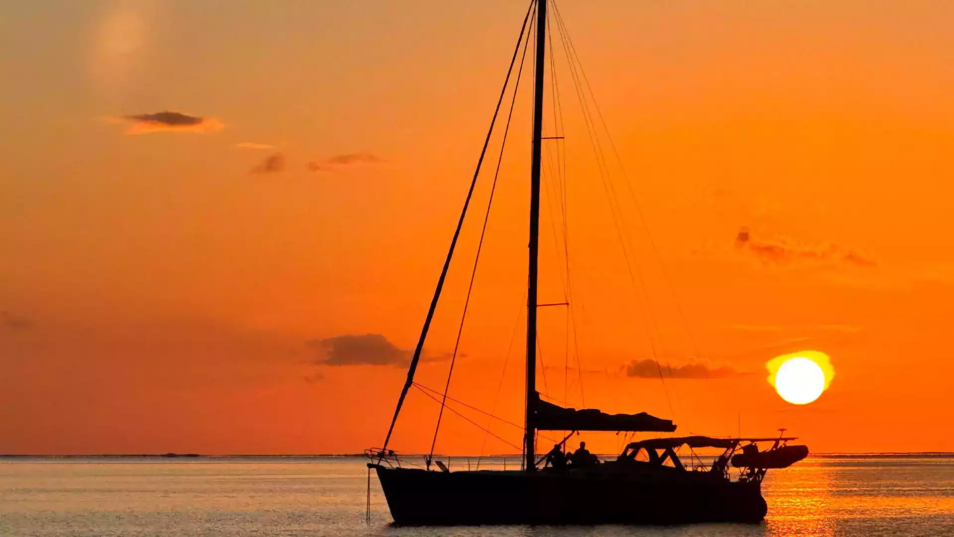 Sunset over a Polynesian lagoon from a catamaran